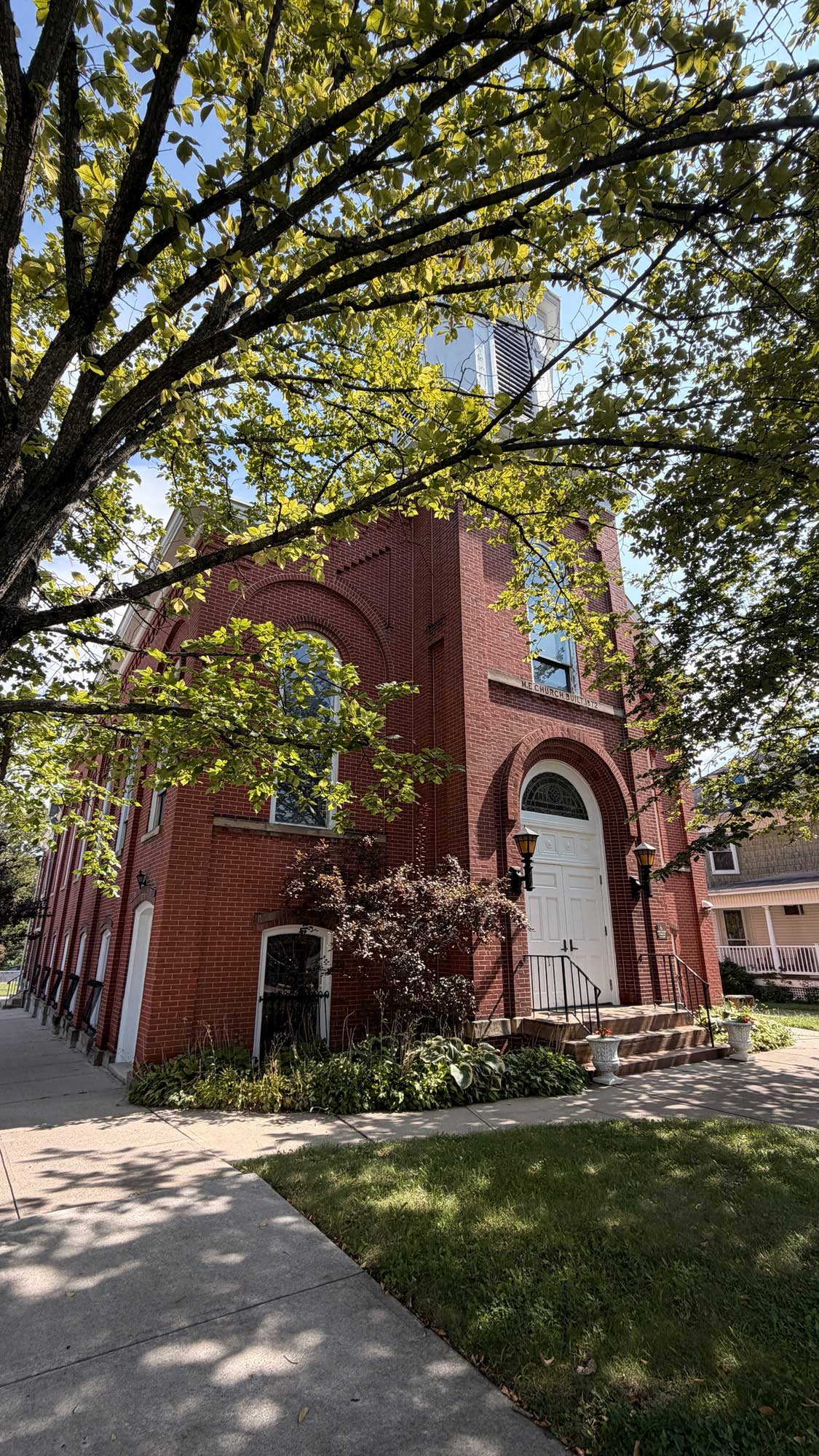 Red-brick exterior and welcoming entrance of United Methodist Church at Milltown